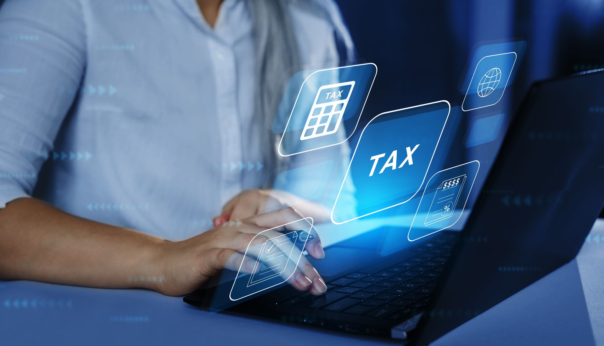 Business Woman using a laptop with digital graphic screen to complete income tax form online. Financial research,government taxes and calculation tax return concept. Tax Time